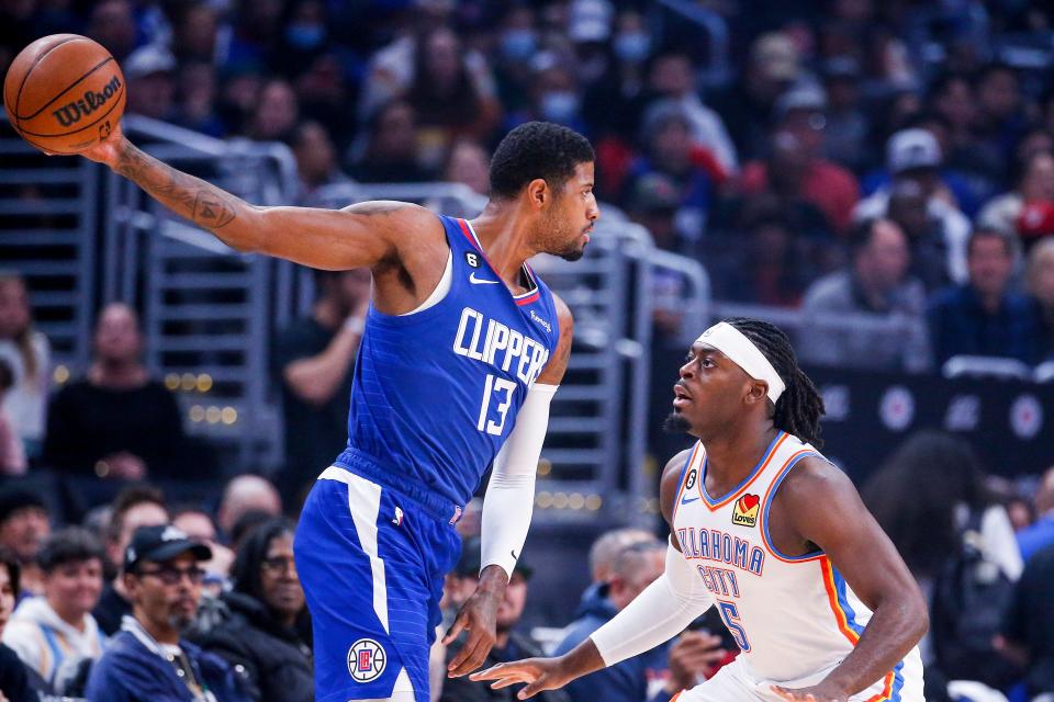 Clippers forward Paul George (13) is defended by Thunder guard Luguentz Dort (5) during the first half of the game on March 21 in Los Angeles.