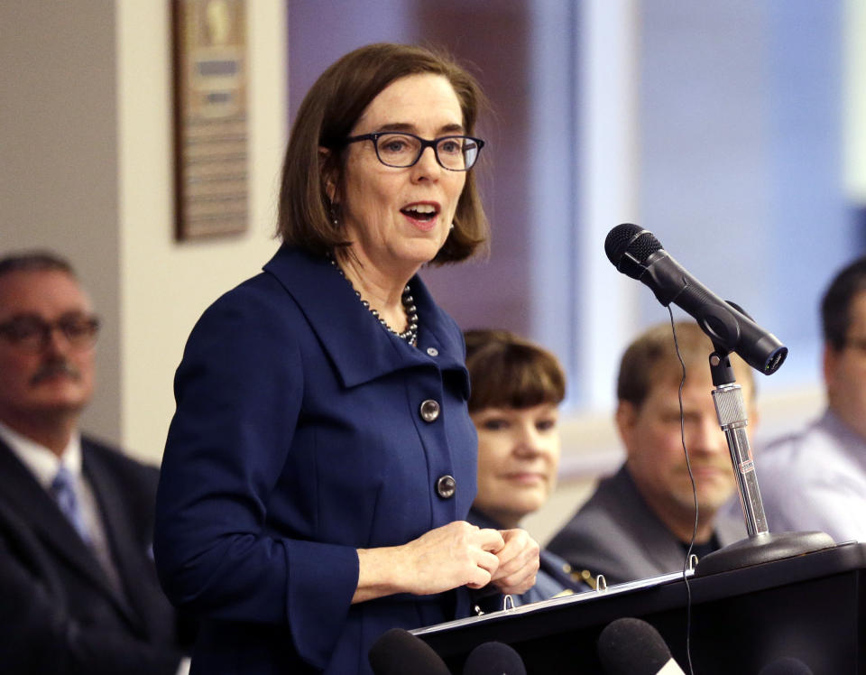 FILE - In this Feb. 2, 2018 file photo, Oregon Gov. Kate Brown speaks in Portland, Ore. The evangelist Franklin Graham recently asked thousands of people at an Oregon rally to pray for the state's Democratic governor, saying she should be a Christian. Yoga and meditation suit Brown just fine, she told reporters Thursday, Aug. 9, 2018, when asked if she follows a certain faith. (AP Photo/Don Ryan, File)