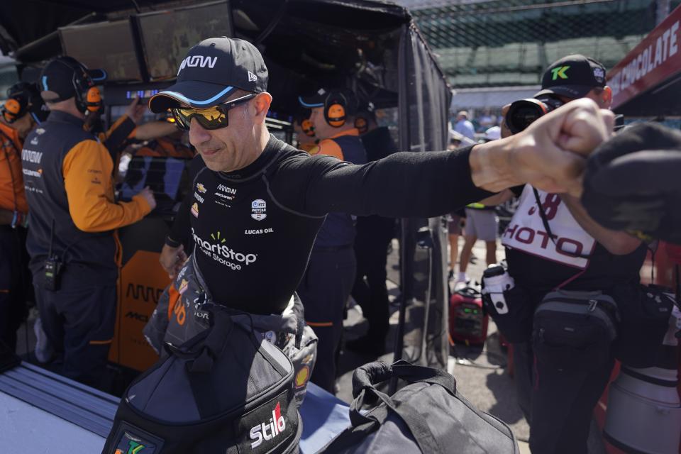 Tony Kanaan, of Brazil, gets a fist bump before the final practice for the Indianapolis 500 auto race at Indianapolis Motor Speedway, Friday, May 26, 2023, in Indianapolis. (AP Photo/Darron Cummings)