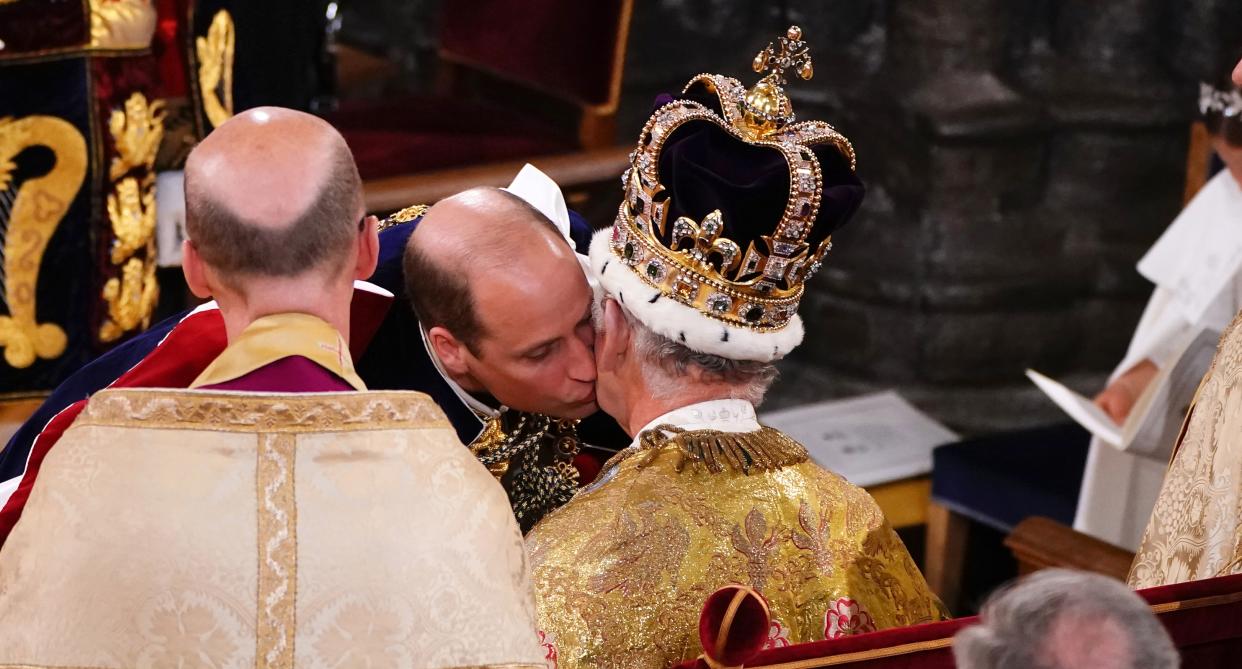 William plants a kiss on his father's cheek during King Charles' coronation. (Getty Images)