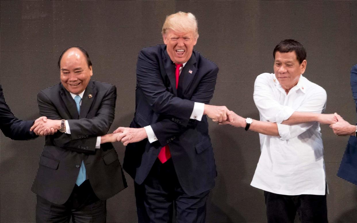 Donald Trump with Vietnamese President Tran Dai Quang and Philippine President Rodrigo Duterte during his tour of Asia - AP