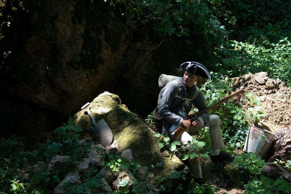 Actor Henry Spadt poses for a portrait near the cave history nerds suspect was a hideout for the Doan Gang during the Revolutionary War at a private property in Buckingham on Friday, July 22, 2022.
