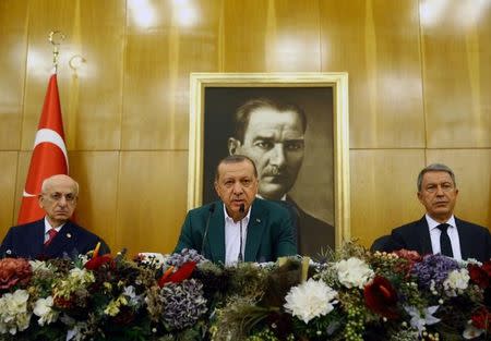 Turkish President Tayyip Erdogan, accompanied by Parliament Speaker Ismail Kahraman and Chief of Staff, General Hulusi Akar, speaks during a news conference at Ataturk airport in Istanbul, Turkey, September 17, 2017. Kayhan Ozer/Presidential Palace/Handout via REUTERS