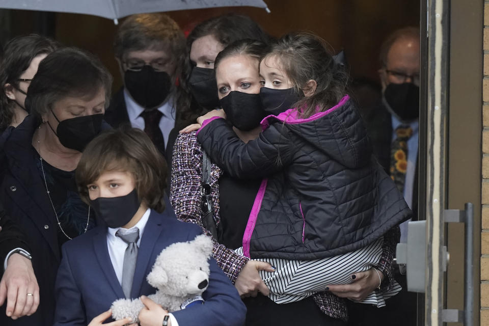 Shannon Terranova, center right, wife of the late U.S. Capitol Police officer William "Billy" Evans, carries her daughter Abigail Evans, 7, right, while walking with her son Logan Evans, 9, front left, and Evan's mother Janice Evans, left, as they depart St. Stanislaus Kostka Church following a funeral Mass for her husband, in Adams, Mass., Thursday, April 15, 2021. Evans, a member of the U.S. Capitol Police, was killed on Friday, April 2, when a driver slammed his car into a checkpoint he was guarding at the Capitol. (AP Photo/Steven Senne)