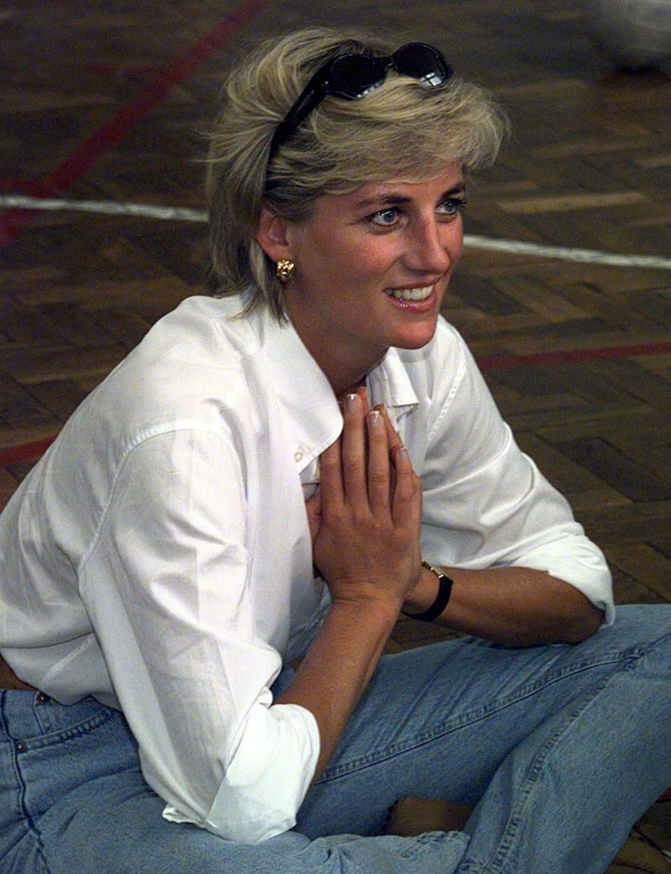 FILE PHOTO 9AUG97 - Diana, Princess of Wales sits cross-legged on the floor as she chats with members of a Zenica volleyball team who have suffered injuries from mines August 9, during Diana's visit to Bosnia and Herzegovina. Diana was seriously injured in a car crash in Paris early Sunday, French police said. Harrods heir Dodi Al Fayed was killed in the accident, which occurred shortly after midnight, police added.    FRANCE DIANA