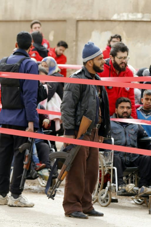 An armed fighter arrives at a checkpoint to be processed as he prepares to leave the last rebel-held area of Syria's third city Homs on March 18, 2017 under a Russian-supervised evacuation deal