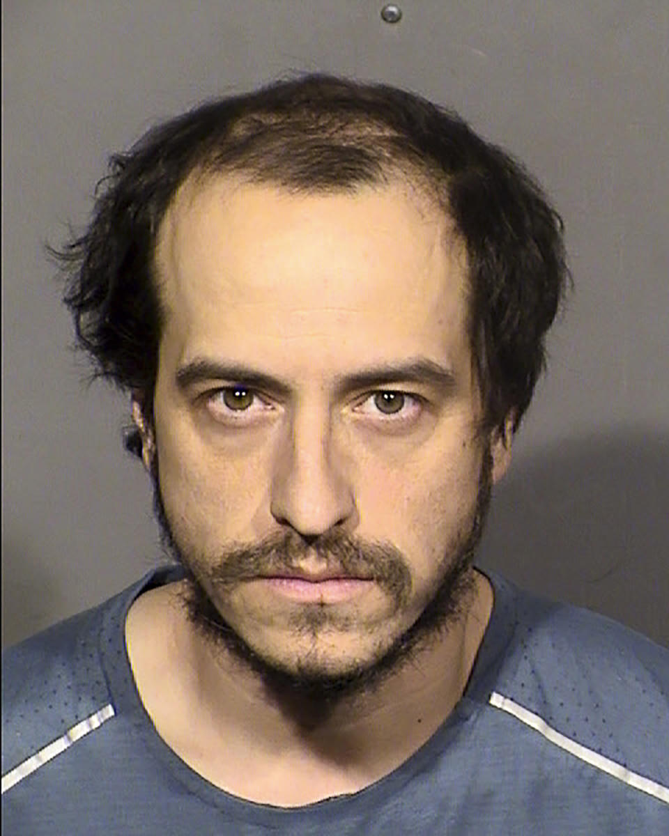 This booking photo released by the Las Vegas Metropolitan Police Department shows suspect Michael Sanchez, 37, after he was arrested in Las Vegas on Sunday, Jan. 29, 2023. Sanchez, accused of telephoning threats to “shoot up” a Southern Nevada synagogue, made an initial court appearance Wednesday, Feb. 1, 2023, in Las Vegas. He faces a felony charge of threatening an act of terrorism. He was not asked to enter a plea, pending a preliminary hearing of evidence scheduled for Feb. 15. (Las Vegas Metropolitan Police Department via AP)