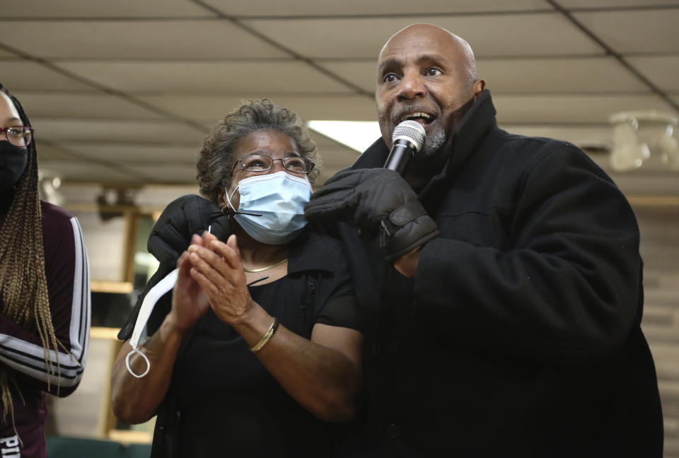Patricia Banks, center, claps while being hugged by Frederick Brown, pastor of Faith Center Church in Bluefield, West Va., on Saturday, Jan. 24, 2021. (AP Photo/Jessie Wardarski)