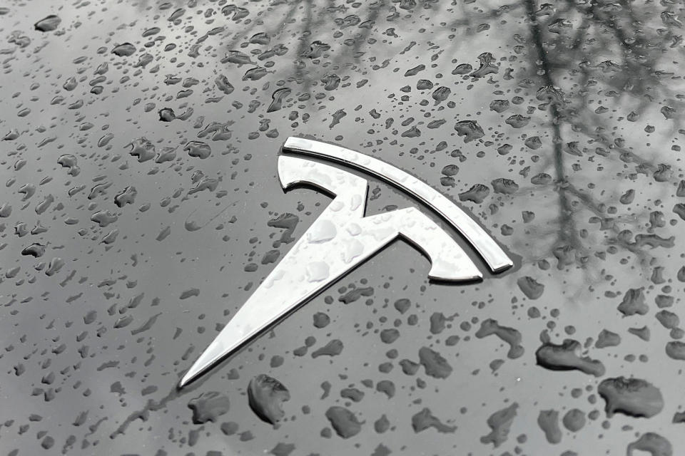 Raindrops are seen next to the Tesla logo on the bonnet of a Tesla electric car in Berlin's Kreuzberg district on January 8, 2023. - Tesla has delivered 1.31 million electric vehicles in 2022 -- a record for the US automaker and a 40 percent jump from a year before, but still short of its own and Wall Street's expectations. (Photo by David GANNON / AFP) (Photo by DAVID GANNON/AFP via Getty Images)