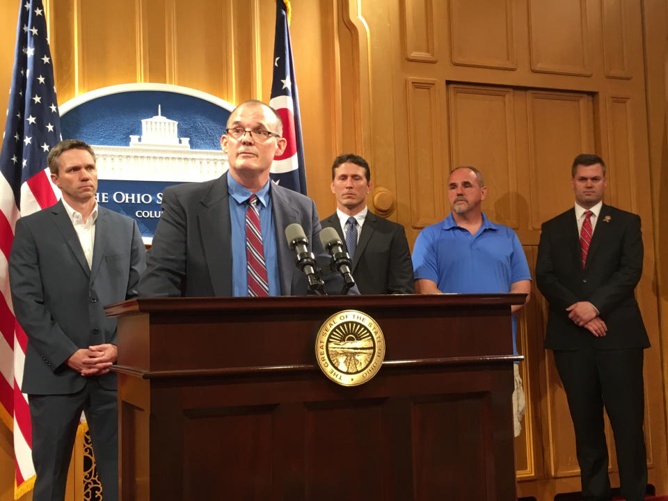 FILE - In a Tuesday, June 4, 2019 file photo, Roger Beedon discusses how sexual misconduct by now-deceased Ohio State team doctor Richard Strauss has affected his life, during a news conference with fellow Strauss accusers, from left, Brian Garrett, Dan Ritchie and Mike Flusche, and state Rep. Brett Hillyer, at the Statehouse in Columbus, Ohio. Men who say they were sexually abused by longtime Ohio State team doctor Richard Strauss are recounting how it changed their lives to make their case that the university owes them financial compensation. (AP Photo/Kantele Franko, File)