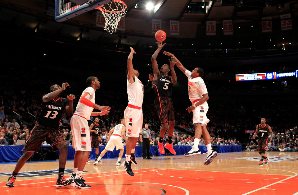 NEW YORK, NY - MARCH 09: Justin Jackson #5 of the Cincinnati Bearcats shoots over Fab Melo #51 and Kris Joseph #32 of the Syracuse Orange during the semifinals of the Big East men's basketball tournament at Madison Square Garden on March 9, 2012 in New York City. (Photo by Chris Trotman/Getty Images)