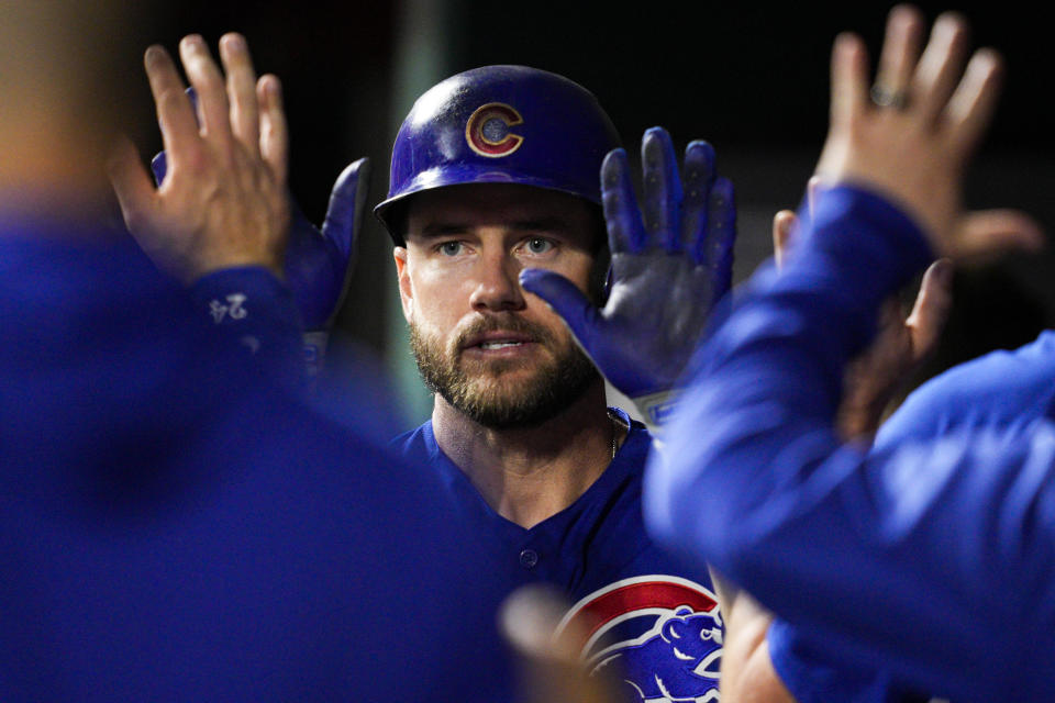 Chicago Cubs' Patrick Wisdom, center, celebrates with teammates after scoring on a single by Miles Mastrobuoni in the seventh inning of a baseball game against the Cincinnati Reds in Cincinnati, Tuesday, April 4, 2023. (AP Photo/Jeff Dean)