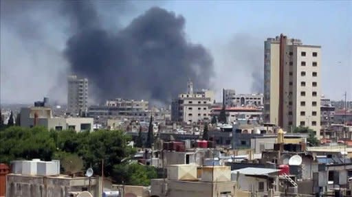 An image grab taken from a video released by the United Nations Supervision Mission in Syria (UNSMIS) shows smoke rising following shelling from the central flashpoint city of Homs on June 11