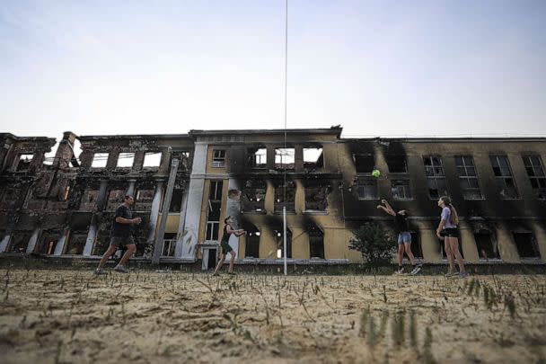 PHOTO: Roman Tetelocko (40), a resident of Kharkiv is seen playing a volleyball with his daughter and her two friends at the sports field located in the playground of a school building, June 10, 2022, in Kharkiv, Ukraine. (Anadolu Agency via Getty Images)