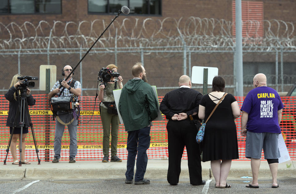 Protestors are photographed by members of the media outside the Nebraska State Penitentiary in the public area, Tuesday, Aug. 14, 2018 in Lincoln, Neb. Nebraska carried out its first execution in more than two decades on Tuesday with a drug combination never tried before, including the first use of the powerful opioid fentanyl in a lethal injection. Carey Dean Moore, 60, was pronounced dead at 10:47 a.m. Moore had been sentenced to death for killing two cab drivers in Omaha in 1979.(Eric Gregory /Lincoln Journal Star via AP)