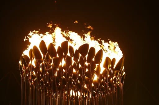 The Olympic flame is seen in the stadium during the opening ceremony of the London 2012 Olympic Games, on July 27