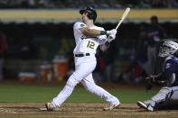 Oakland Athletics' Sean Murphy watches his two-run single in front of Minnesota Twins catcher Ryan Jeffers during the seventh inning of a baseball game in Oakland, Calif., Tuesday, May 17, 2022. (AP Photo/Jed Jacobsohn)