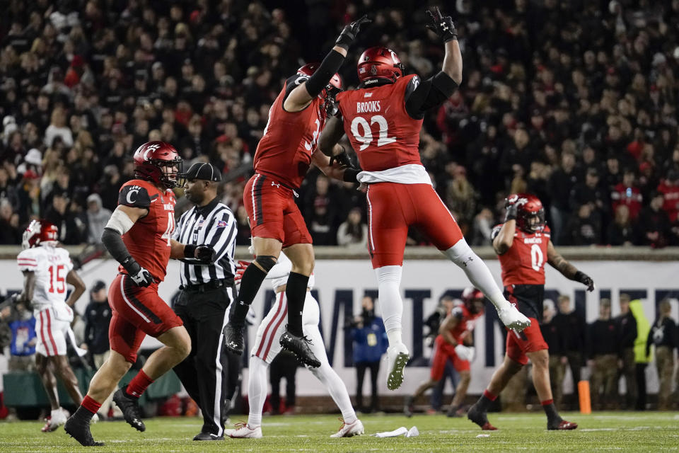 Cincinnati defensive lineman Curtis Brooks (92) celebrates with teammates after making a stop on third down during the second half of the American Athletic Conference championship NCAA college football game against Houston Saturday, Dec. 4, 2021, in Cincinnati. (AP Photo/Jeff Dean)