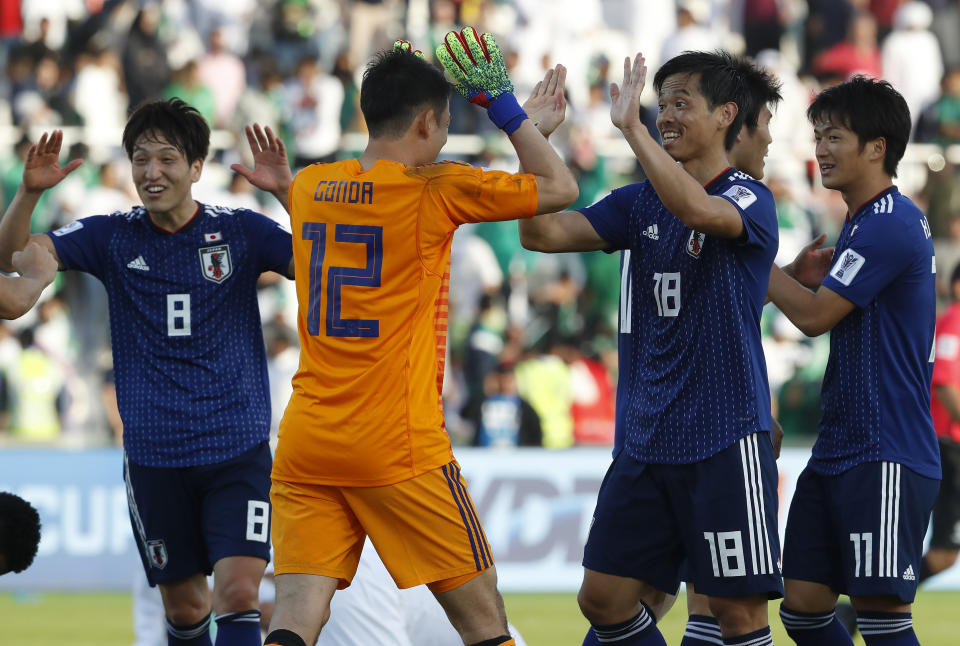 Japan's goalkeeper Shuichi Gonda, left, and Hidemasa Morita celebrate after the AFC Asian Cup round of 16 soccer match between Japan and Saudi Arabia at the Sharjah Stadium in Sharjah, United Arab Emirates, Monday, Jan. 21, 2019. Japan won the match 1-0. (AP Photo/Hassan Ammar)