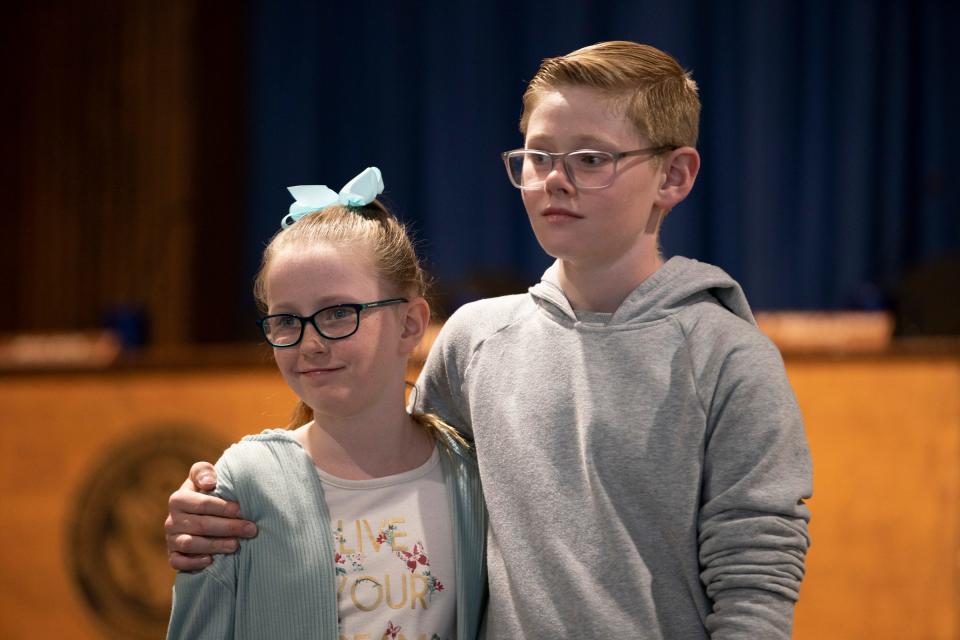 Raelyn Reeves, left, stands with her brother Dillon Reeves, 13, a seventh grader at Carter Middle School in Warren, who made a heroic move when he brought his school bus to a safe stop after the driver fell ill and unconscious this week. Surrounded by his family, Warren Consolidated Schools Superintendent Robert Livernois holds a news conference Thursday, April 27, 2023.