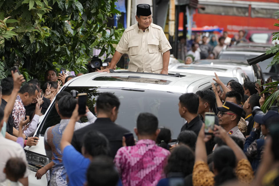 Indonesian Defense Minister and presidential frontrunner Prabowo Subianto greets supporters before visited the grave of Habib Ali bin Abdurrahman Al-Habsyi at the Al Riyadh Mosque in Jakarta, Indonesia, Friday, Feb. 16, 2024. Prabowo Subianto’s rise as Indonesia’s apparent next president is a dramatic comeback from a notorious past, which saw the United States banning his entry over human rights and the Indonesian army, where he led the special forces, expelling him. (AP Photo/Achmad Ibrahim)