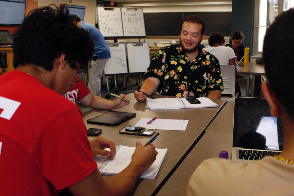 Angel Hope, center, works on a math problem, part of an intense six-week summer bridge program for students of color and first-generation students at the University of Wisconsin, in Madison, Wis., July 27, 2022. Hundreds of thousands of recent graduates are heading to college this fall after spending more than half their high school careers dealing with the upheaval of a pandemic. Hope says he didn't feel ready for college after online classes in high school caused him fall behind but says the bridge classes made him feel more confident. (AP Photo/Carrie Antlfinger)