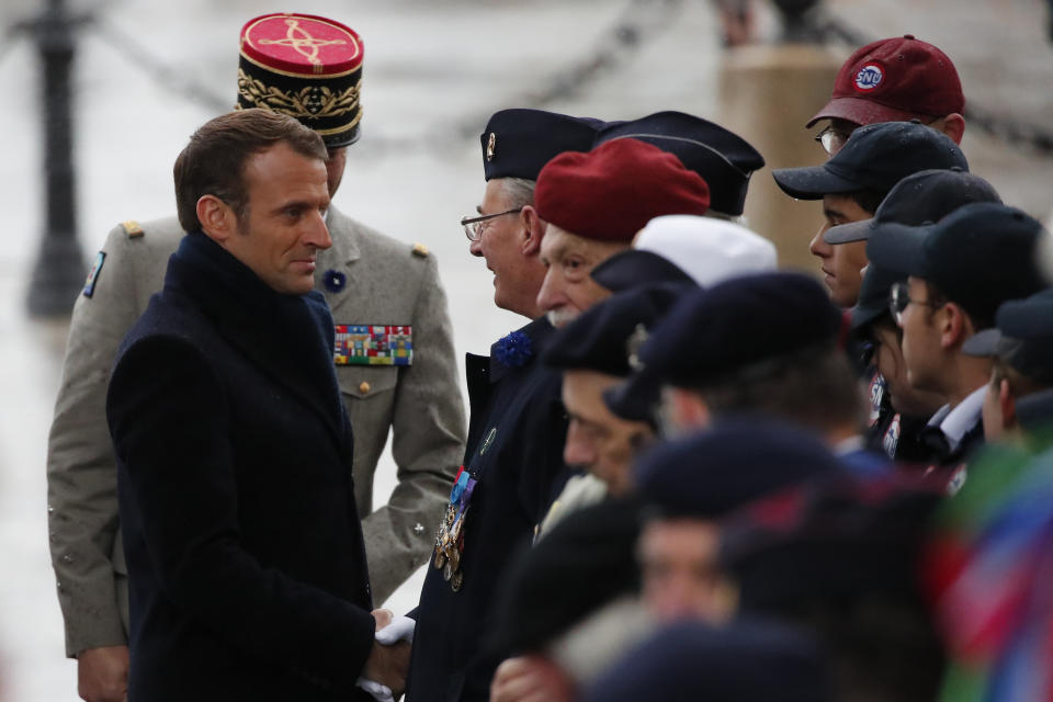 French President Emmanuel Macron meets veterans under the Arc de Triomphe during commemorations marking the 101st anniversary of the 1918 armistice, ending World War I, Monday Nov. 11, 2019 in Paris (AP Photo/Francois Mori, Pool)