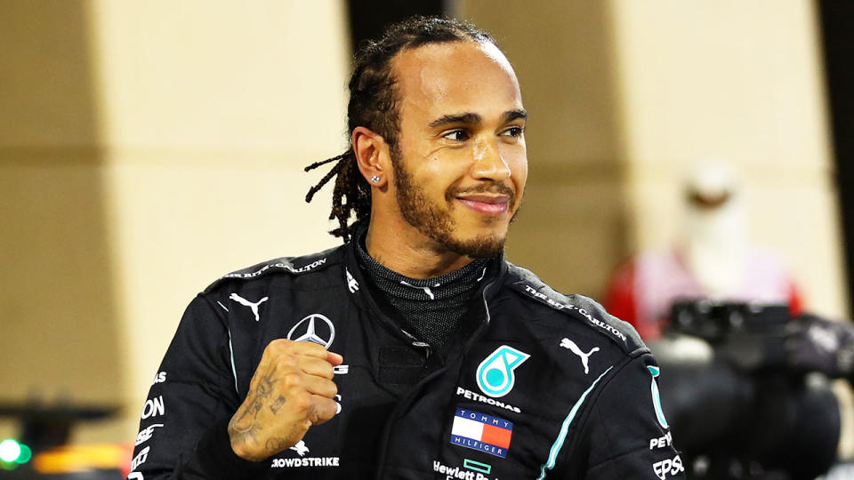 Pictured here, seven-time F1 world champion Lewis Hamilton gives a fist bump towards his team.