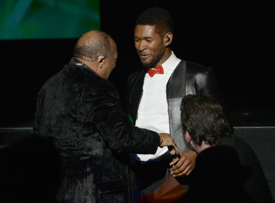 LOS ANGELES, CA - APRIL 18:  Singer Usher presents inductee Quincy Jones (L) the Ahmet Ertegun Award for Lifetime Achievement on stage at the 28th Annual Rock and Roll Hall of Fame Induction Ceremony at Nokia Theatre L.A. Live on April 18, 2013 in Los Angeles, California.  (Photo by Kevin Winter/Getty Images)