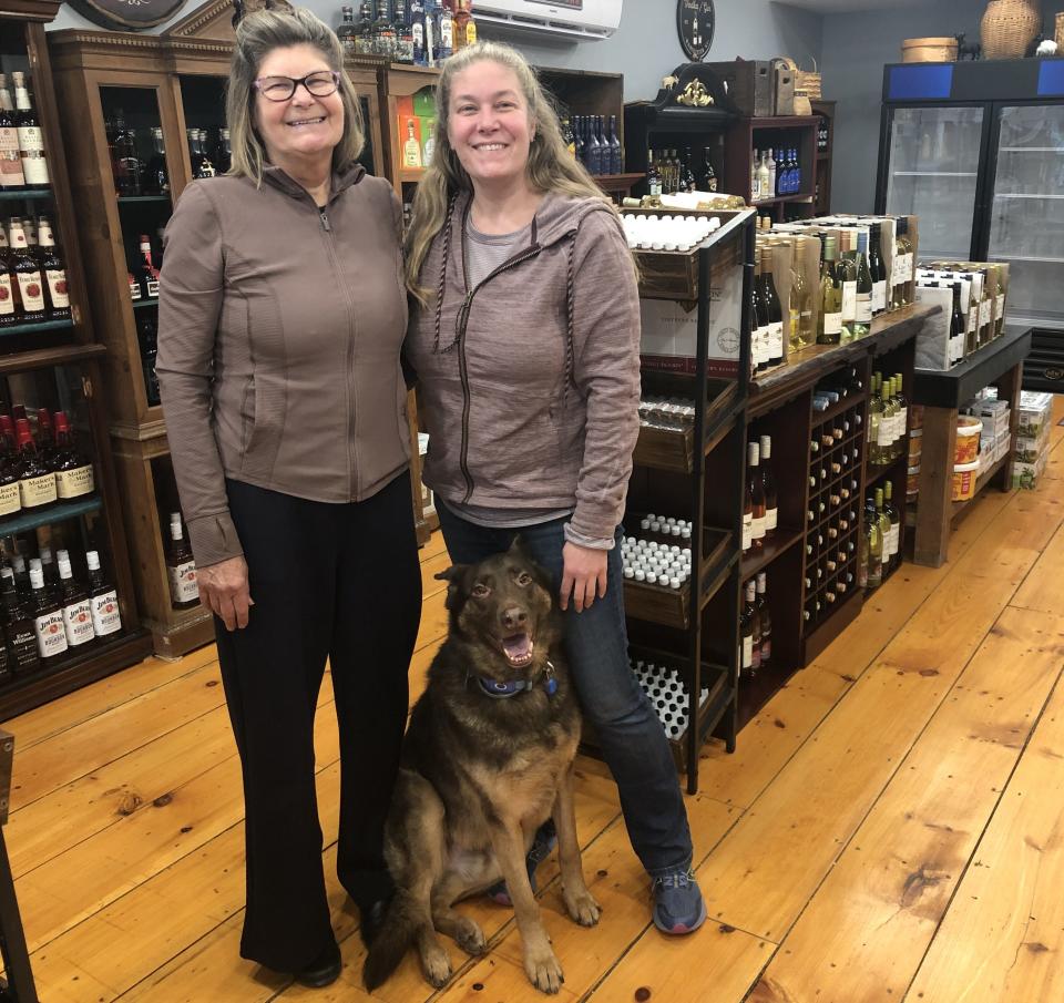 Martha Yudicky owns Goat Tribe Wine & Spirits, which opened earlier this month in Manchester. Daughter Jessica Nash also works at the store, with the help of her dog, Link.