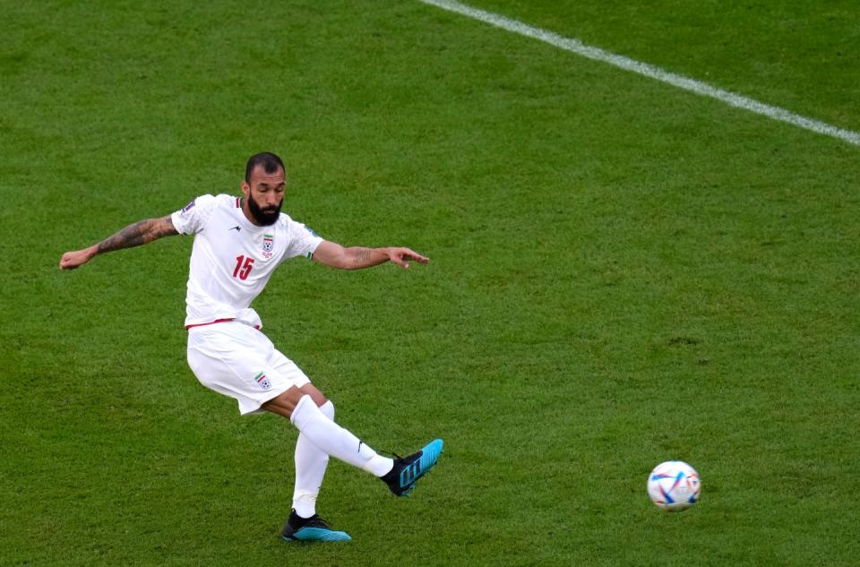 Iran's Rouzbeh Cheshmi scores his side's opening goal during the World Cup group B football match between Wales and Iran, at the Ahmad Bin Ali Stadium in Al Rayyan , Qatar, Friday, Nov. 25, 2022. (AP Photo/Manu Fernandez)