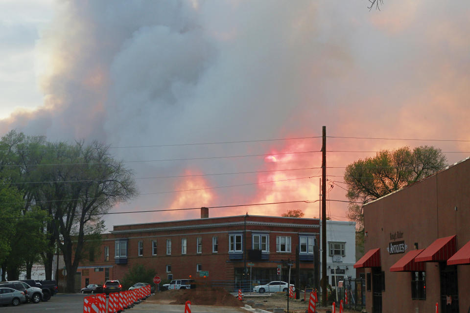 A sunset is seen through plumes wildfire smoke in Las Vegas, N.M., on Saturday, May 7, 2022. Area residents have been on and off of evacuation orders of the past month as fires grow and move with intense and unpredictable winds. (AP Photo/Cedar Attanasio)