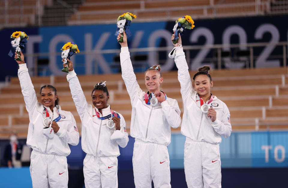 <p>TOKYO, JAPAN - JULY 27: Jordan Chiles, Simone Biles, Grace McCallum and Sunisa Lee of Team United States react on the podium after winning the silver medal during the Women's Team Final on day four of the Tokyo 2020 Olympic Games at Ariake Gymnastics Centre on July 27, 2021 in Tokyo, Japan. (Photo by Laurence Griffiths/Getty Images)</p> 