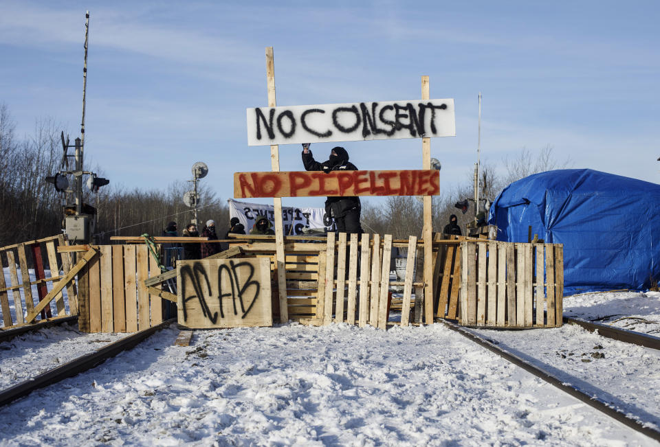 Supporters of the Wet'suwet'en who are against the LNG pipeline, block a Canadian National Railway line just west of Edmonton, Alberta, on Wednesday, Feb. 19, 2020. (Jason Franson/The Canadian Press via AP)