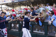 Mississippi closing pitcher Brandon Johnson, right, and Derek Diamond high five fans following their 4-2 victory over Oklahoma in Game 2 of the NCAA College World Series baseball finals, Sunday, June 26, 2022, in Omaha, Neb. Mississippi defeated Oklahoma 4-2 to win the championship. (AP Photo/Rebecca S. Gratz)