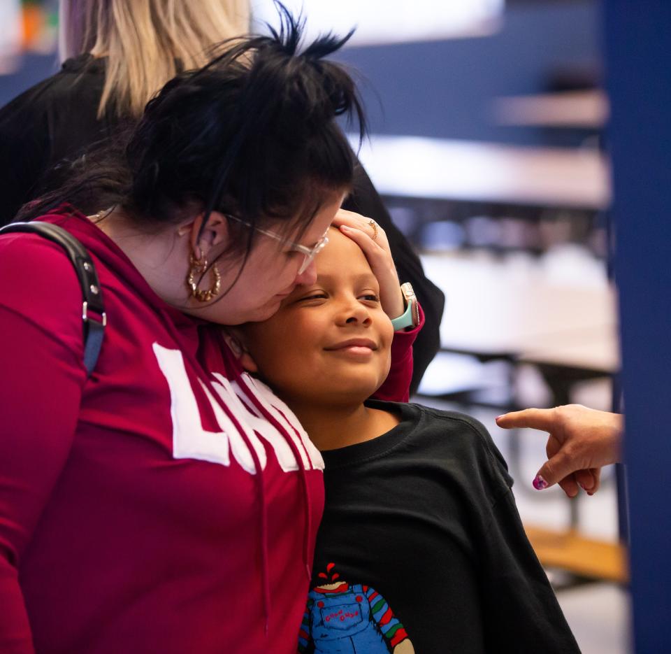 Ashley Penska, left, gives her son Karson a hug after attending the year-round school meeting Thursday. “We have kids at other schools. It’s making (it) very hard for a single mother,” Penska said.