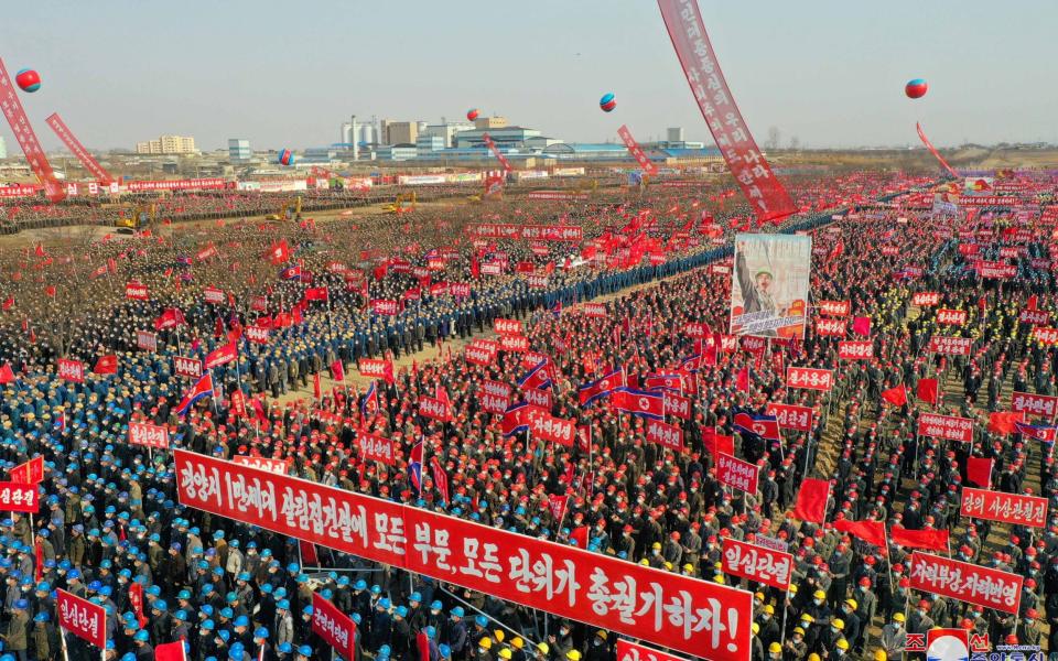 Workers attend a mass ceremony to inaugurate the start of construction on a building project in Pyongyang on March 24 - KCNA /via REUTERS 