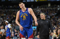 Denver Nuggets center Nikola Jokic (15) walks away from Minnesota Timberwolves assistant coach Micah Nori after a brief exchange in the second half of Game 1 of an NBA basketball second-round playoff series Saturday, May 4, 2024, in Denver. (AP Photo/David Zalubowski)