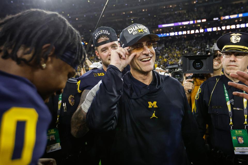Michigan's Jim Harbaugh celebrates after winning the national championship on Monday in Houston.