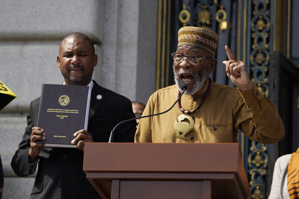 Rev. Amos Brown speaks during a rally in support of reparations for African Americans as Supervisor Shamann Walton listens outside City Hall in San Francisco, Tuesday, Sept. 19, 2023. (AP Photo/Eric Risberg)