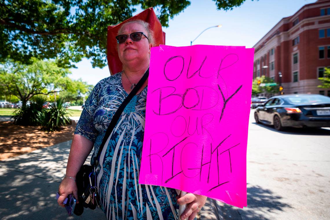 In this June 24 file photo, Betina Timbrook stands in front of the Tarrant County Courthouse and holds a sign in protest of the U.S. Supreme Court decision to overturn Roe v. Wade.