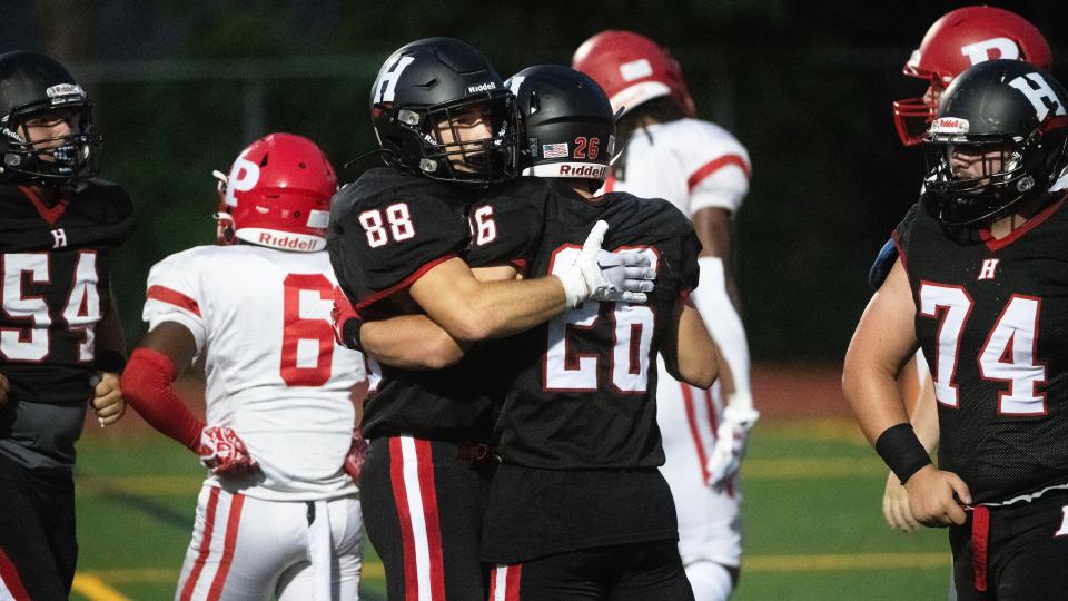 Haddonfield's Dominic Hahn, center right, is congratulated by teammate Matt LaProcido after Hahn scored a touchdown during the football game between Haddonfield and Paulsboro played at Haddonfield High School on Friday, September 1, 2023.  Haddonfield defeated Paulsboro, 35-7.  