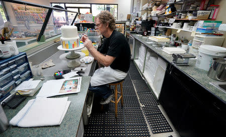 Baker Jack Phillips decorates a cake in his Masterpiece Cakeshop in Lakewood, Colorado U.S. September 21, 2017. Picture taken September 21, 2017. REUTERS/Rick Wilking