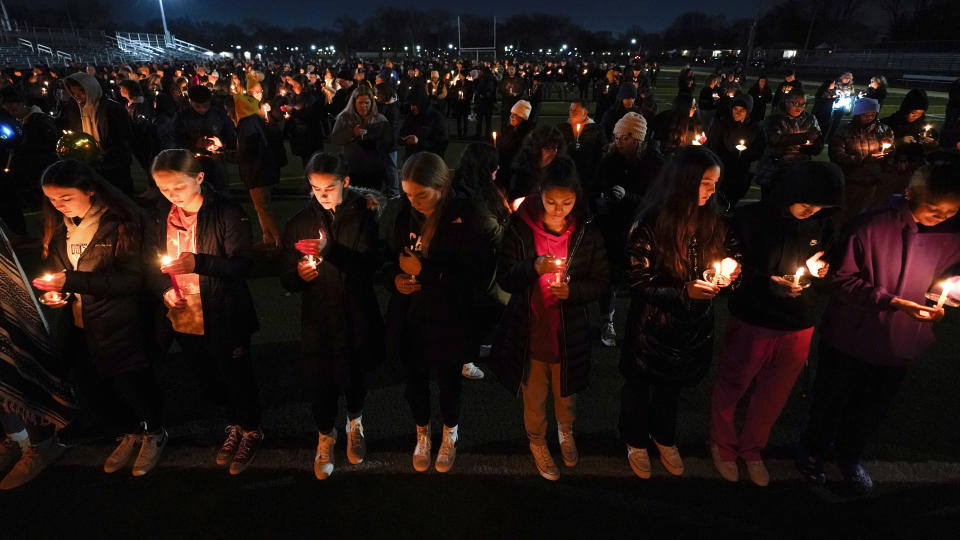 Mourners attend a candlelight vigil for Alexandria Verner at the Clawson High School football field in Clawson, Mich., Tuesday, Feb. 14, 2023. Verner was among the students killed after a gunman opened fire on the campus of Michigan State University Monday night. (AP Photo/Paul Sancya)