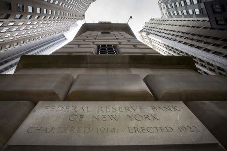 FILE PHOTO: The corner stone of the New York Federal Reserve Bank is seen surrounded by financial institutions in New York City, New York, U.S., March 25, 2015. REUTERS/Brendan McDermid/File Photo