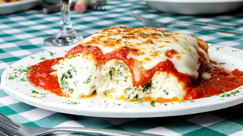 Manicotti with herb and ricotta filling on plate