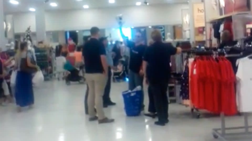 The 40-year-old holds up a pair of the skates that he told shoppers and staff were 