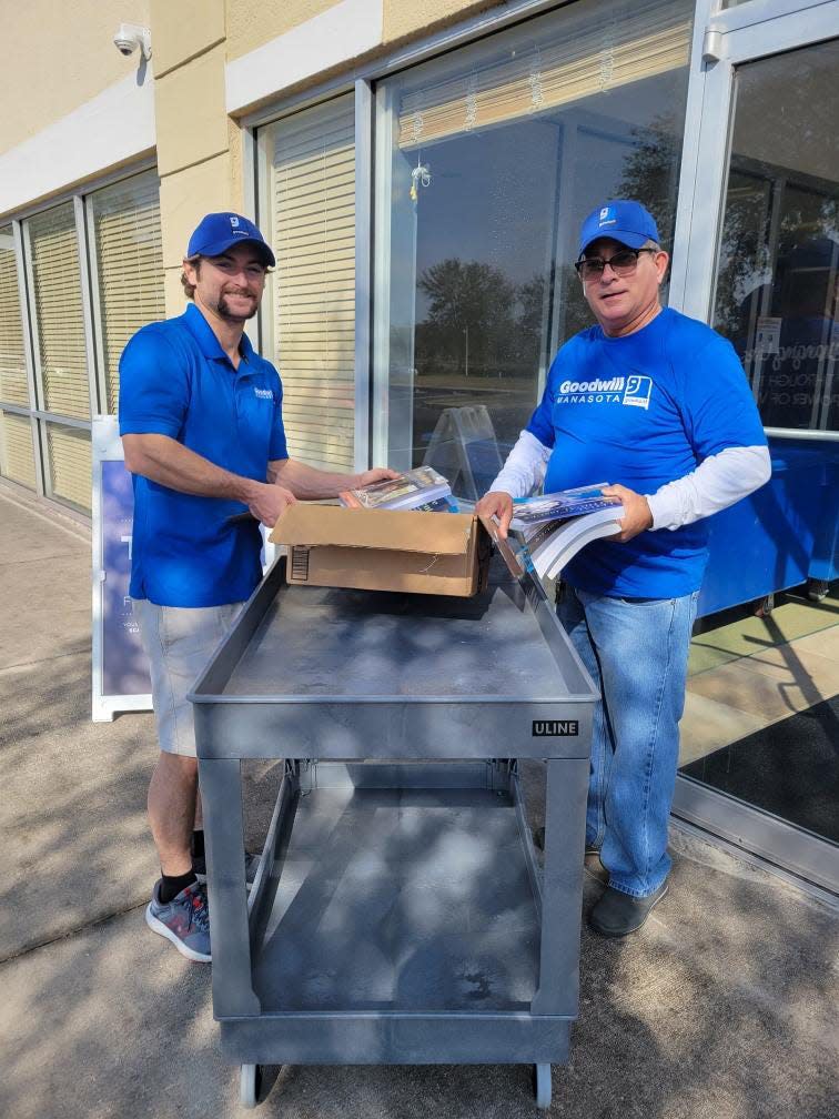 Thomas Bloomfield, assistant team lead, ADC operations, with Jesus Baracaldo, ADC attendant, work at the new Goodwill Manasota