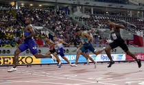 Christian Coleman, of the United States, crosses the line ahead of Aaron Brown, of Canada, and Adam Gemili, of Great Britain, in a men's 100 meter semifinal at the World Athletics Championships in Doha, Qatar, Saturday, Sept. 28, 2019. (AP Photo/David J. Phillip)