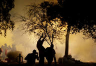 <p>Pepper spray engulfs protesters outside the Phoenix Convention Center, Tuesday, Aug. 22, 2017, in Phoenix. Protests were held against President Donald Trump as he hosted a rally inside the convention center. (AP Photo/Matt York) </p>